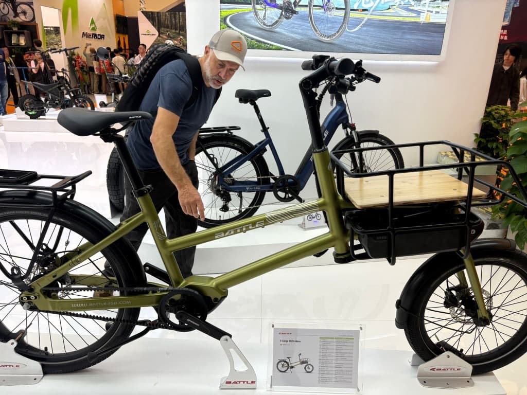 Matt inspecting a cargo e-bike on a manufacturer stand at China Cycle
